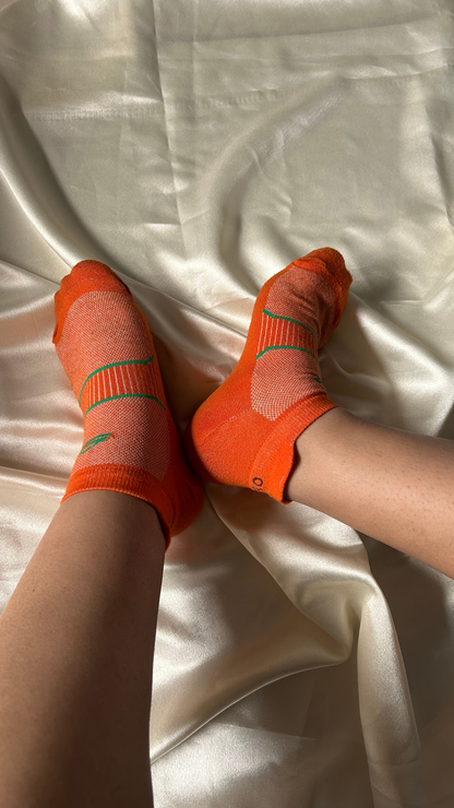 Model showcasing Hyper X Collar gym socks – vibrant orange socks with a bold collar design, perfect for intense workouts, offering comfort and style during your fitness routine.