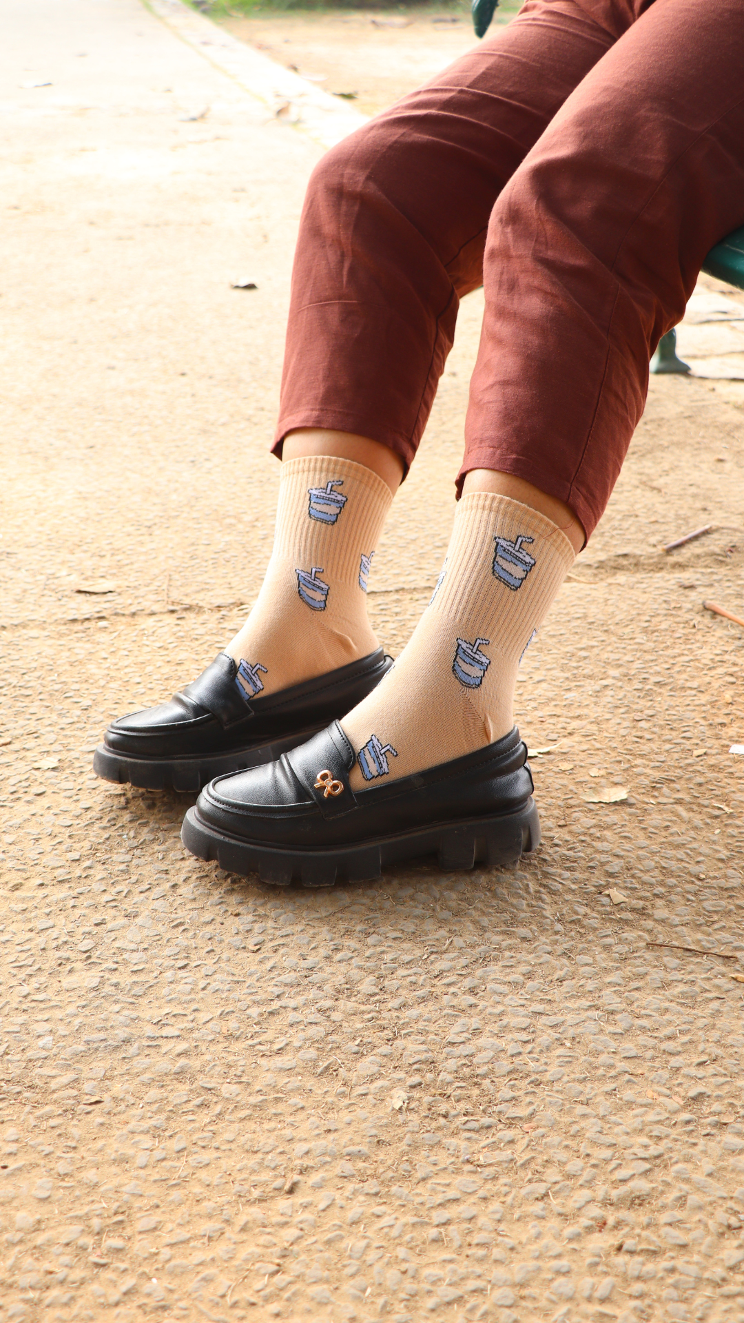 Model wearing Tangy Mojito funky socks – beige crew-length cotton socks with refreshing mojito print for cocktail lovers.